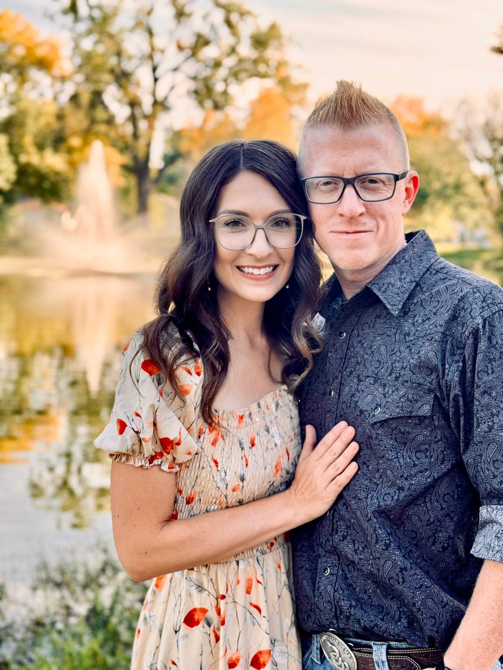 Caleb and Tamara Wheat standing in front of a pond